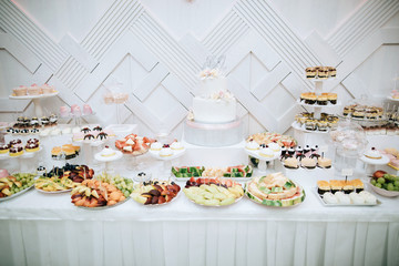 Delicious white wedding reception candy bar dessert table