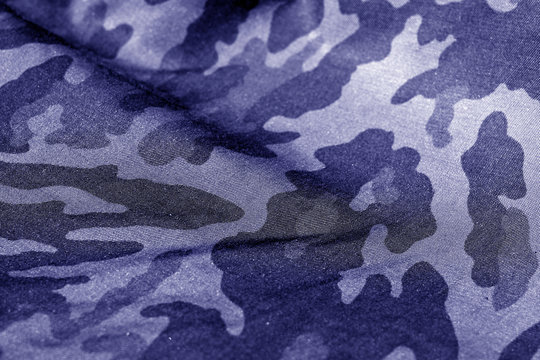 Military uniform pattern with blur effect in blue tone.