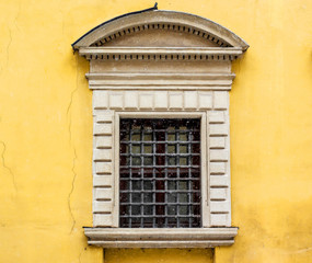 Ancient window closed by a metal lattice