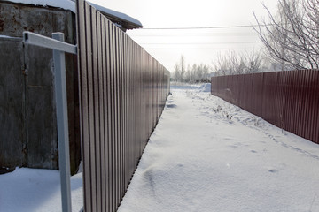 Fence made of metal in snow in winter