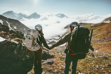 Couple Man and Woman holding hands enjoying mountains landscape Love and Travel Lifestyle concept...