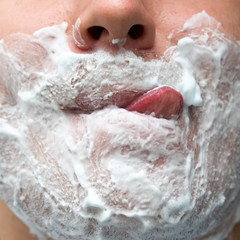 Fototapeta premium A man is applying face shaving foam