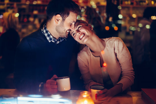 Romantic Couple Dating In Pub At Night