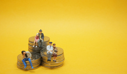 Business concept. People sitting on a pile of silver coins.