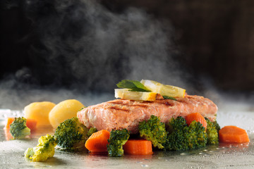 Salmon and steamed vegetables.