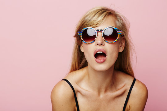 Beautiful woman looking surprised in sunglasses