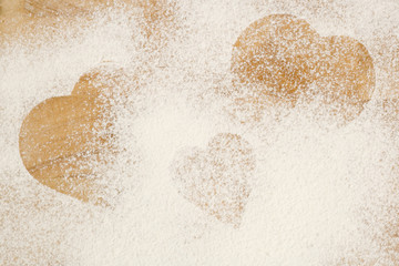 Heart shaped patterns in a flour dusted background
