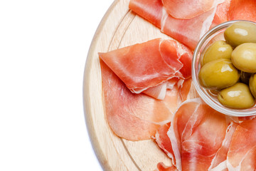 Meat plate of Italian prosciutto crudo or spanish jamon on wooden cutting board