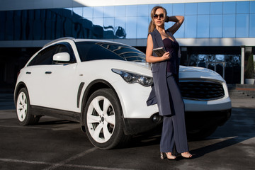 Business woman on a background of white cars