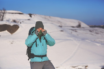 Fototapeta na wymiar Mountaineer, covering his face with a scarf.