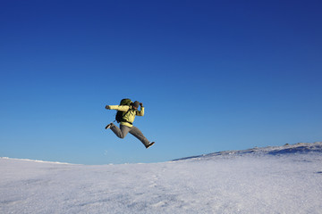 Naklejka na ściany i meble fly jump hiker in winter.