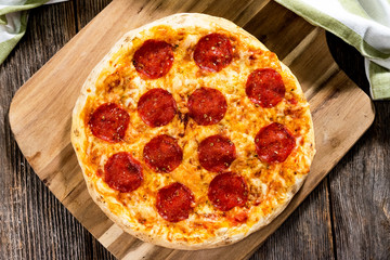 Pepperoni pizza on rustic background