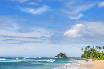Picturesque beach and blue sky. Coastline of Sri Lanka.