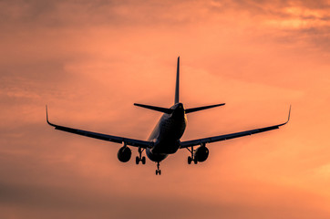 Airplane landing at sunset