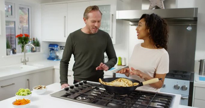 4K Cheerful couple cooking together with woman explaining her methods, Lifestyle TV presenters in the studio