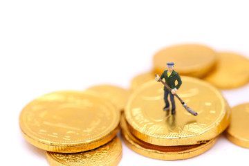 Miniature people : Cleaning personnel with golden coins.