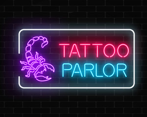 Tattoo parlor glowing neon signboard with scorpio emblem. Tattooing salon sign in rectangle frame.