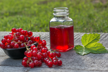 Jar of red currant jelly and fresh berries.