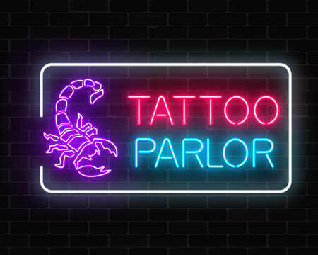 Tattoo parlor glowing neon signboard with scorpio emblem. Tattooing salon sign in rectangle frame.
