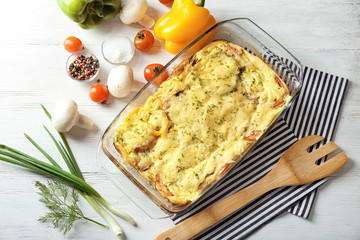 Glass baking dish with delicious casserole on table, top view. Fresh from oven