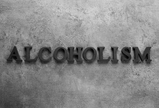 Word "Alcoholism" on grey background