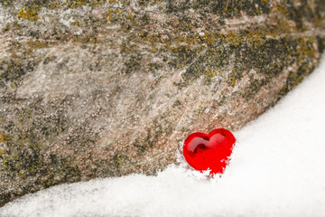 red heart on the snow on background of the old stone love Valentine's day background texture