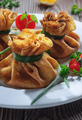 Pancakes with meat, tied with green onions