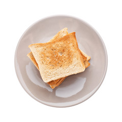 Plate with toasted bread on white background