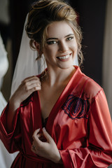 Naklejka premium Lovely bride and bridesmaids next to the big window