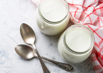 Fototapeta na wymiar Greek yogurt in glass jars.