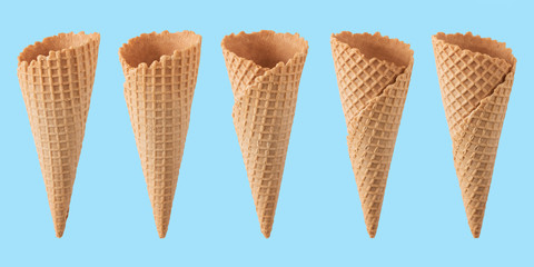 Various ice cream cones isolated on blue background.