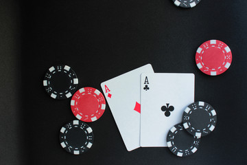 Obraz premium Poker concept on black background. Chips and cards. Copy space