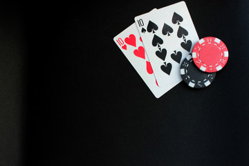 Poker concept on black background. Chips and cards