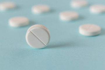 White pills on the bright blue background.