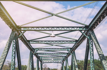 Fototapeta premium Old green metal bridge and old light bulb with film style. in Chiangmai. 