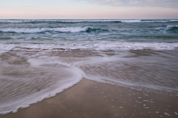 beautiful breaking waves on sandy beach on atlantic ocean, basque country, france