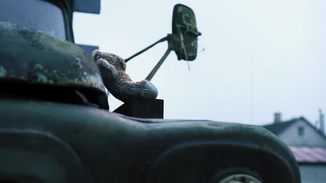 Old abandoned desolate military retro truck and near children's bear toy. Chernobyl