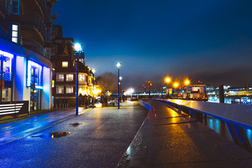 lone street in the night at thames river in london
