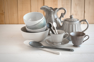 white bowl and spoon ceramic on a gray background