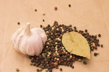 Fugural still life photo image of pile of spices, garlic, craft paper and pepper balls