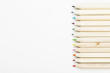 Obraz premium Accessories to drawing - colored pencils on white background. Top view, copy space