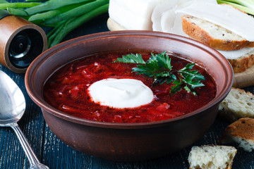 Traditional Ukrainian Russian vegetable borscht soup on the old wooden background