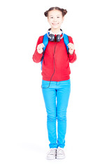 Portrait of Asian school girl posing on white background with backpack and headphones around her neck