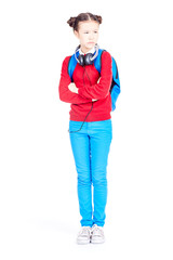 Fototapeta premium Portrait of Asian school girl posing on white background with backpack and headphones around her neck