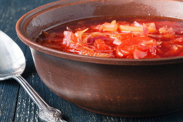Traditional Ukrainian Russian vegetable borscht soup on the old wooden background