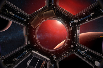 View from a porthole of space station on the Mars background. Elements of this image furnished by NASA.