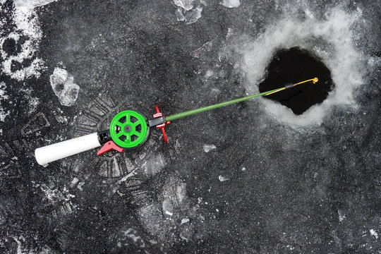  fishing rod in ice on ice,  close up
