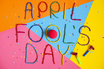 Funny font first april fools day written in plastecine of different colors.