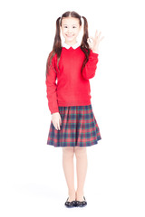 Asian female elementary student in school uniform posing on white background