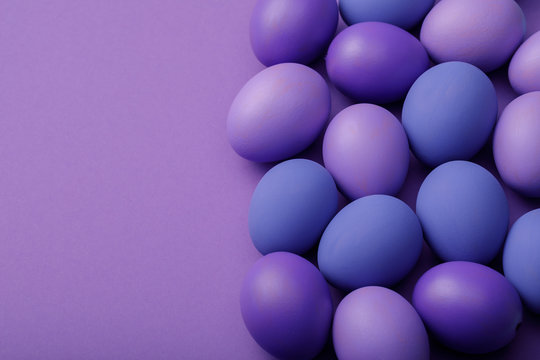 Purple easter eggs on a paper background with space for text © Sergey Chayko